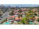 Aerial view of a residential neighborhood with mature landscaping, swimming pools and the Las Vegas skyline in the distance at 2704 Miraflores Ave, Las Vegas, NV 89102