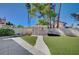 Backyard featuring artificial turf, a shed, a cinderblock wall, and mature landscaping at 2704 Miraflores Ave, Las Vegas, NV 89102