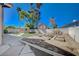 Backyard featuring artificial turf, a shed, a cinderblock wall, mature landscaping, and garden boxes at 2704 Miraflores Ave, Las Vegas, NV 89102