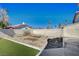 A yard featuring garden beds, a brick wall, and partial artificial grass at 2704 Miraflores Ave, Las Vegas, NV 89102