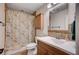 Cozy bathroom with a shower/tub combo, modern sink and a neutral color palette at 2704 Miraflores Ave, Las Vegas, NV 89102