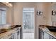 Modern bathroom showcasing granite countertops, dark wood cabinets, and glass-enclosed shower at 2704 Miraflores Ave, Las Vegas, NV 89102