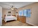 Cozy bedroom with natural light, neutral colors, carpet, and a ceiling fan at 2704 Miraflores Ave, Las Vegas, NV 89102