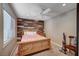 Bedroom featuring a wood accent wall, a fan, and a window with plantation shutters at 2704 Miraflores Ave, Las Vegas, NV 89102