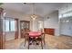Cozy dining room featuring tiled floors, natural light, and a charming chandelier at 2704 Miraflores Ave, Las Vegas, NV 89102