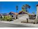 Charming single-story home featuring a two-car garage, landscaped front yard, and gated entry on a sunny day at 2704 Miraflores Ave, Las Vegas, NV 89102
