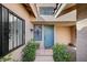 Front entrance with an light blue door, secure window and decorative wrought iron at 2704 Miraflores Ave, Las Vegas, NV 89102