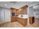 Modern kitchen with wooden cabinets, quartz countertops, and stainless steel appliances at 2704 Miraflores Ave, Las Vegas, NV 89102