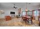 Open-concept living room featuring a fireplace, TV, dining area, and comfortable seating at 2704 Miraflores Ave, Las Vegas, NV 89102