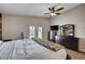 Bedroom featuring wood floors, a ceiling fan, access to the backyard, and a modern dresser at 2704 Miraflores Ave, Las Vegas, NV 89102