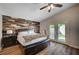 Bedroom featuring a wood accent wall, hardwood floors, and private access to the backyard at 2704 Miraflores Ave, Las Vegas, NV 89102