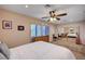 This bedroom features carpet flooring, a ceiling fan, and natural light from the windows at 2704 Miraflores Ave, Las Vegas, NV 89102