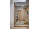 A tiled walk-in shower features dual shower heads, a glass door, and a built-in bench at 2704 Miraflores Ave, Las Vegas, NV 89102