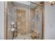 A tiled walk-in shower features dual shower heads, a glass door, and a built-in bench at 2704 Miraflores Ave, Las Vegas, NV 89102