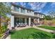 Wide backyard featuring artificial turf, covered patio with seating, ideal for outdoor relaxation and gatherings at 28 Verde Rosa Dr, Henderson, NV 89011