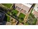 A private outdoor oasis that includes a covered patio, lush greenery, and a manicured backyard at 28 Verde Rosa Dr, Henderson, NV 89011