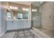 Modern bathroom with double sink vanity, and glass enclosed walk-in shower at 28 Verde Rosa Dr, Henderson, NV 89011