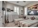 Neutral bedroom featuring two twin beds, a large art piece and plantation shutters at 28 Verde Rosa Dr, Henderson, NV 89011