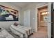 Neutral bedroom featuring a twin bed, a large art piece and access to the bathroom at 28 Verde Rosa Dr, Henderson, NV 89011