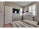 Neutral bedroom featuring two twin beds, a wall mounted television and plantation shutters at 28 Verde Rosa Dr, Henderson, NV 89011