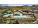 Aerial view of community pool, lounge chairs, and recreation area on a sunny day with palm trees at 28 Verde Rosa Dr, Henderson, NV 89011