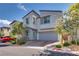 Charming two-story home featuring a two-car garage, neat landscaping, and a welcoming facade at 28 Verde Rosa Dr, Henderson, NV 89011