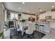 Bright kitchen and dining area featuring modern appliances, an island with seating, and a stylish table set at 28 Verde Rosa Dr, Henderson, NV 89011