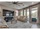 Comfortable living room featuring a large sectional sofa, plush rug, and large windows overlooking the backyard at 28 Verde Rosa Dr, Henderson, NV 89011