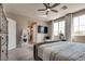 A serene main bedroom features large windows, stylish decor, plush carpet and access to the bathroom at 28 Verde Rosa Dr, Henderson, NV 89011