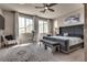 A serene main bedroom with a ceiling fan, large windows, and a stylish rug at 28 Verde Rosa Dr, Henderson, NV 89011