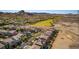 A sprawling neighborhood is set against a backdrop of rugged mountains, showcasing a harmonious blend of urban and natural living at 28 Verde Rosa Dr, Henderson, NV 89011