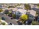 A charming two-story home has a well-maintained yard, complemented by an inviting, tree-lined street in a friendly neighborhood at 28 Verde Rosa Dr, Henderson, NV 89011