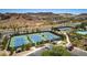 Aerial view of well-maintained community tennis courts offering recreational opportunities and mountain views at 28 Verde Rosa Dr, Henderson, NV 89011