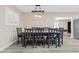 Open-concept dining area featuring a large wooden table, modern light fixtures, and plenty of natural light at 2885 Horseshoe Dr, Las Vegas, NV 89120