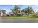 Well-maintained home with a green lawn, mature olive trees, and solar panels on the roof at 2885 Horseshoe Dr, Las Vegas, NV 89120