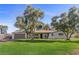 Attractive single-story home with a well-kept lawn, mature trees, and a two-car garage at 2885 Horseshoe Dr, Las Vegas, NV 89120
