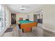 Bright game room featuring a pool table and easy access to the kitchen and outdoor spaces at 2885 Horseshoe Dr, Las Vegas, NV 89120