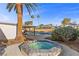 A small and cozy in-ground hot tub sits next to the larger in-ground pool under sunny skies at 2885 Horseshoe Dr, Las Vegas, NV 89120
