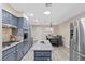 Well-lit kitchen with stainless steel appliances, granite countertops, a central island, and an adjacent dining area at 2885 Horseshoe Dr, Las Vegas, NV 89120
