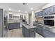 Modern kitchen featuring stainless steel appliances, granite countertops, an island, and ample cabinet space at 2885 Horseshoe Dr, Las Vegas, NV 89120