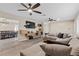 Spacious living room featuring a comfortable sectional sofa, ceiling fans, modern entertainment center, and bright dining area at 2885 Horseshoe Dr, Las Vegas, NV 89120
