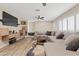 Bright and airy living room featuring a comfortable sectional sofa, ceiling fan, and a stylish entertainment center at 2885 Horseshoe Dr, Las Vegas, NV 89120