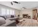Cozy living room showcasing a comfortable sectional sofa, fireplace, and bright natural light from large windows at 2885 Horseshoe Dr, Las Vegas, NV 89120
