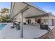 Covered patio with dining table, seating area, grill, and access to the pool, ideal for outdoor dining and entertainment at 2885 Horseshoe Dr, Las Vegas, NV 89120