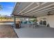 This covered patio is equipped with a dining area and grill, overlooking the pool, ideal for entertainment and leisure at 2885 Horseshoe Dr, Las Vegas, NV 89120