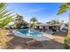 Lovely swimming pool and patio area with a nice desert landscape in the backyard beneath a beautiful sunny sky at 2885 Horseshoe Dr, Las Vegas, NV 89120