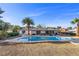 A beautiful backyard with a large rectangular in-ground pool and covered patio with seating and a tall palm tree at 2885 Horseshoe Dr, Las Vegas, NV 89120