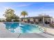 Inviting pool with covered patio area, palm trees, and plenty of space for outdoor lounging and entertaining at 2885 Horseshoe Dr, Las Vegas, NV 89120