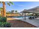 Backyard pool with covered patio area featuring outdoor seating and well manicured landscaping, perfect for leisure and entertaining at 2885 Horseshoe Dr, Las Vegas, NV 89120