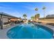 Backyard pool featuring a covered patio, outdoor seating, and palm trees, creating a relaxing outdoor oasis at 2885 Horseshoe Dr, Las Vegas, NV 89120